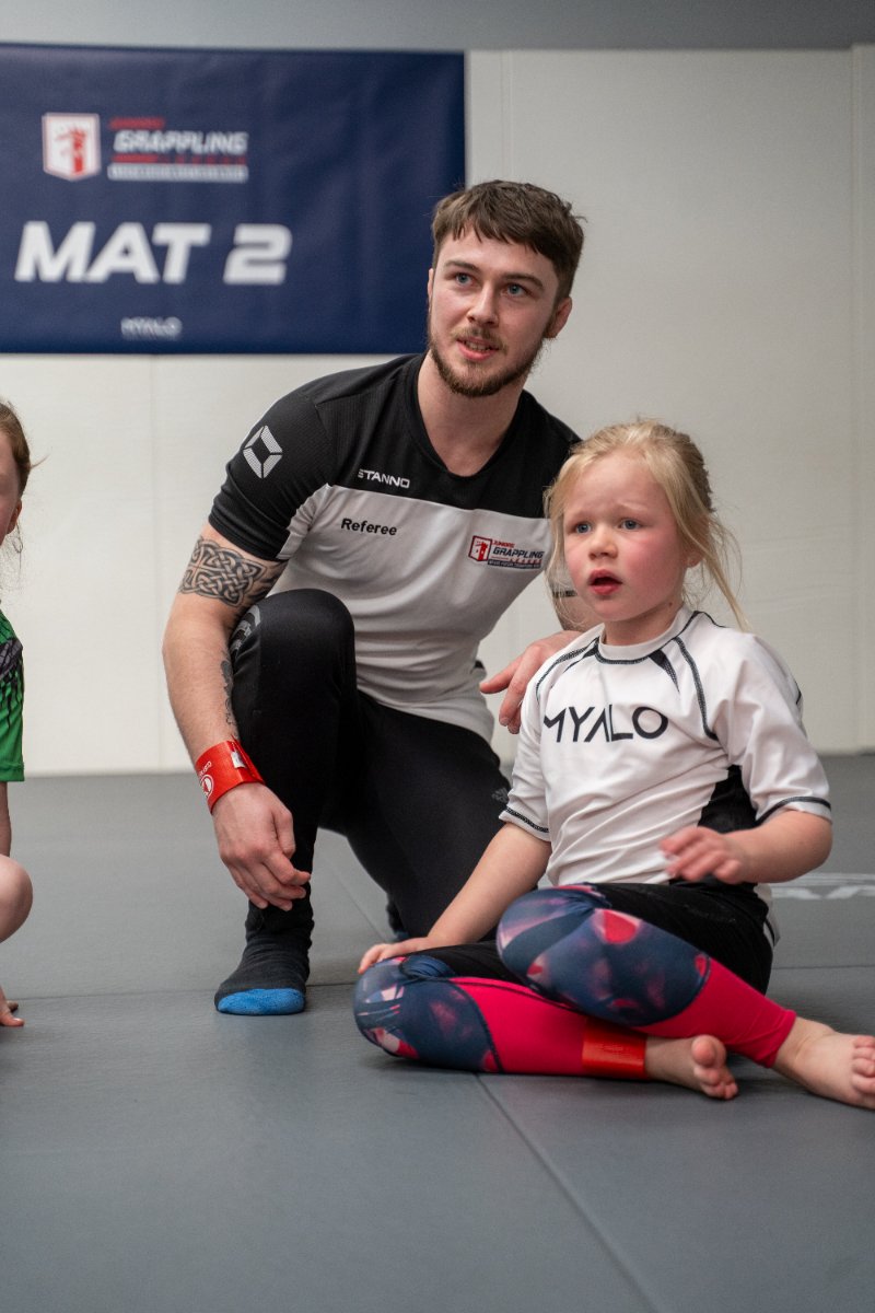 Referee with young competitors on Mat 2